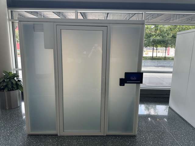 A frosted-glass ZenSpace pod in the GWCC concourse